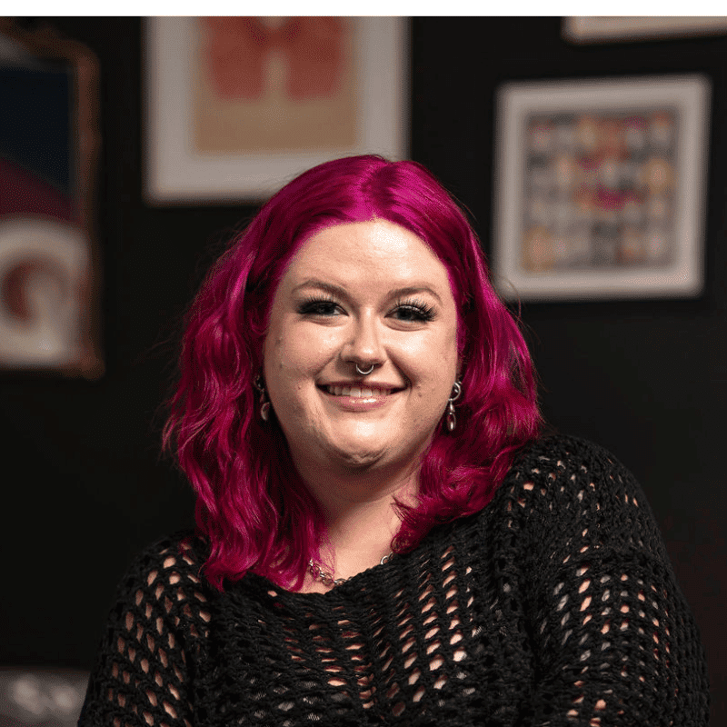 Portrait of Ash (She/Her), a professional stylist at Rebel Hair, showcasing their expertise and style.