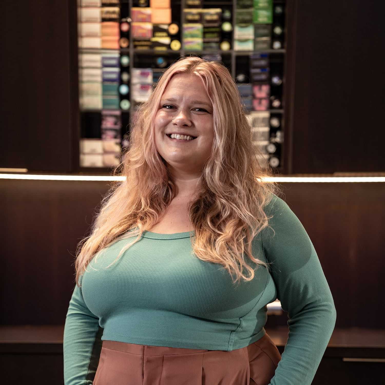 Portrait of Alaina, a professional stylist at Rebel Hair, showcasing their expertise and style.