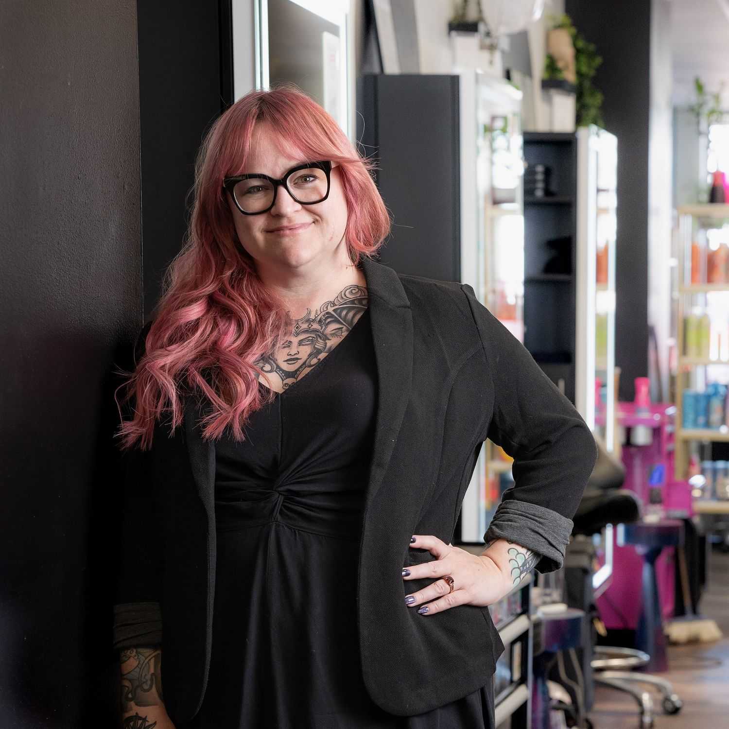 Portrait of Cassie, a professional stylist at Rebel Hair, showcasing their expertise and style.