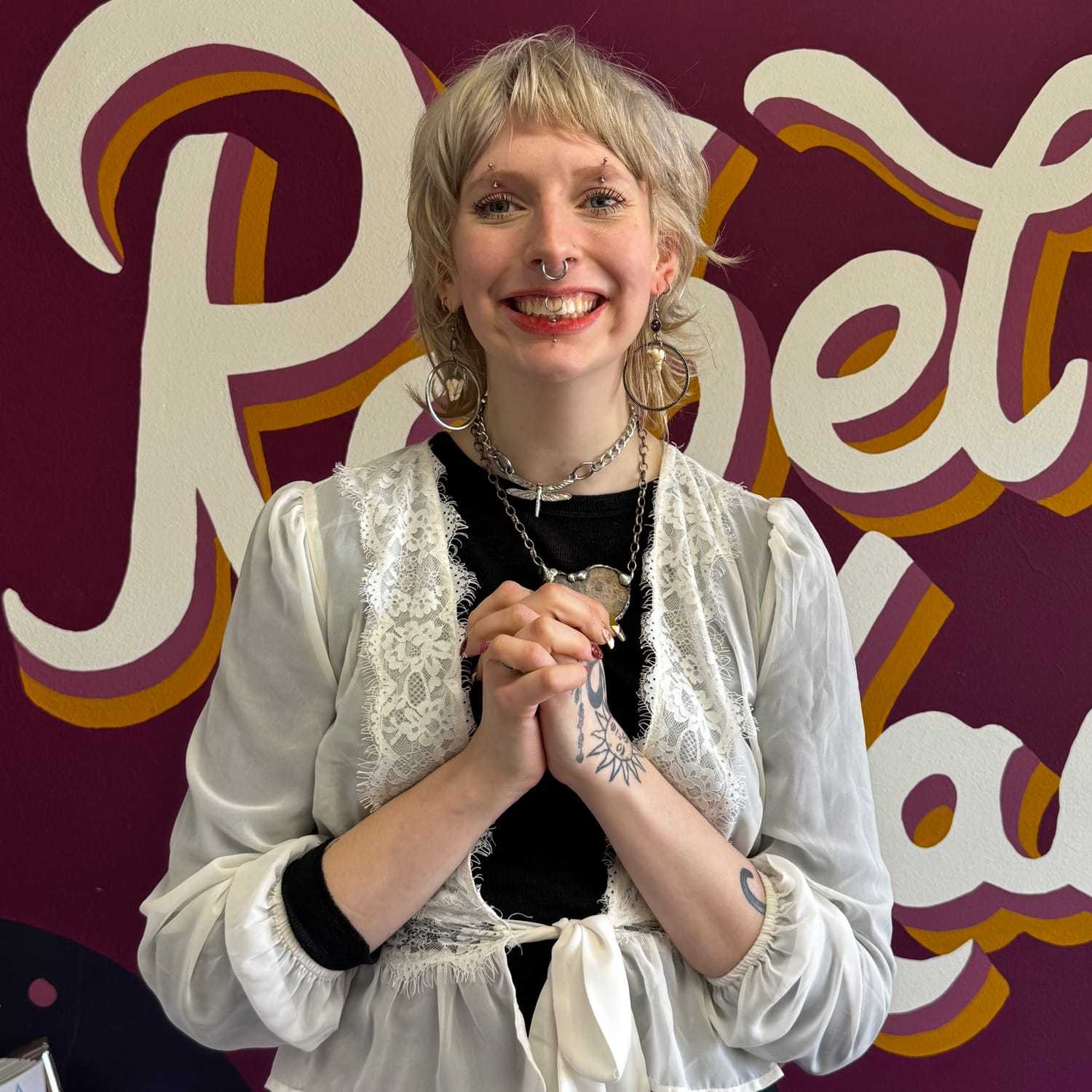 Portrait of Lottie (They/Them), a professional stylist at Rebel Hair, showcasing their expertise and style.