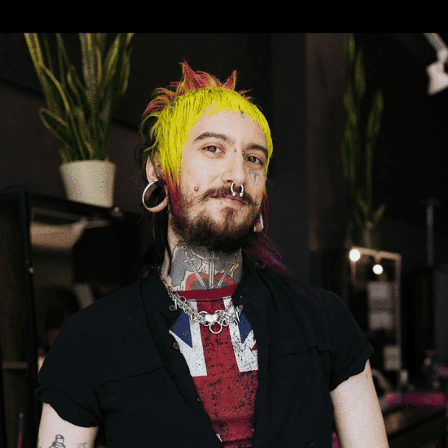 Portrait of Jordy (They/Them), a professional stylist at Rebel Hair, showcasing their expertise and style.