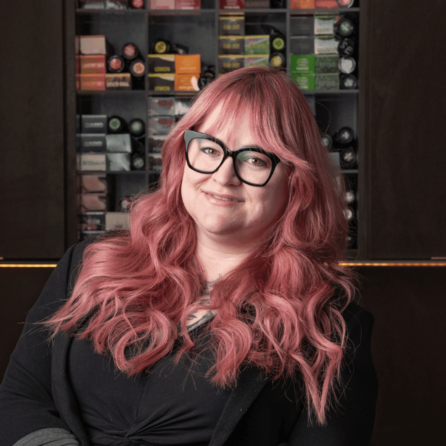 Portrait of Cassie (She/Her), a professional stylist at Rebel Hair, showcasing their expertise and style.