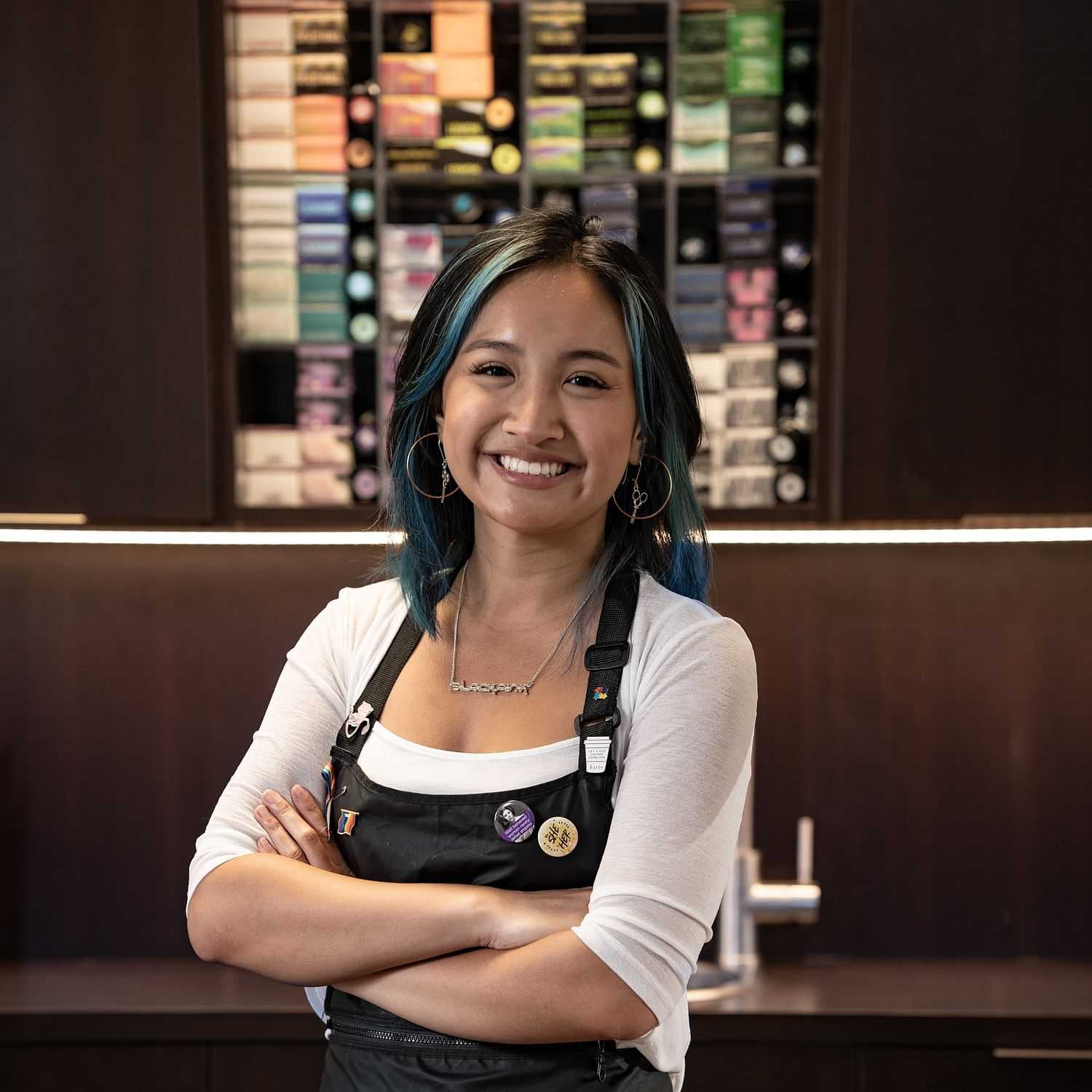 Portrait of May, a professional stylist at Rebel Hair, showcasing their expertise and style.