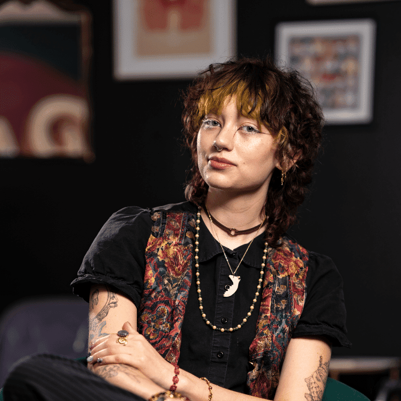 Portrait of Atlas (They/Them), a professional stylist at Rebel Hair, showcasing their expertise and style.