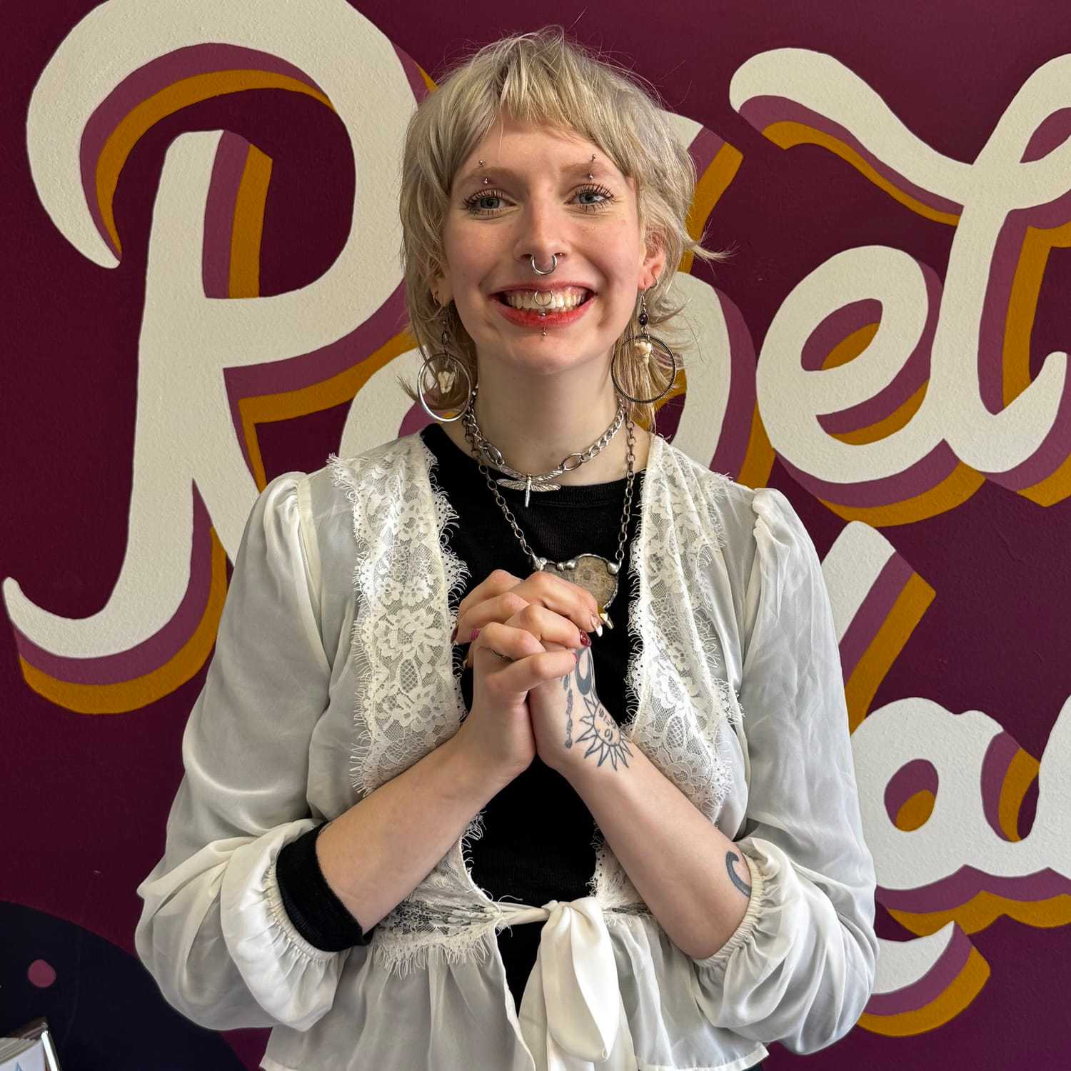 Portrait of Lottie (They/Them), a professional stylist at Rebel Hair, showcasing their expertise and style.